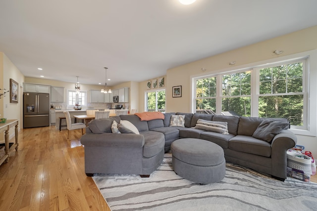 living room featuring light hardwood / wood-style flooring and a chandelier