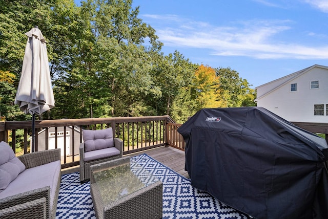 wooden terrace with an outdoor hangout area and grilling area