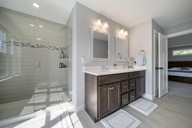 bathroom featuring an enclosed shower and vanity