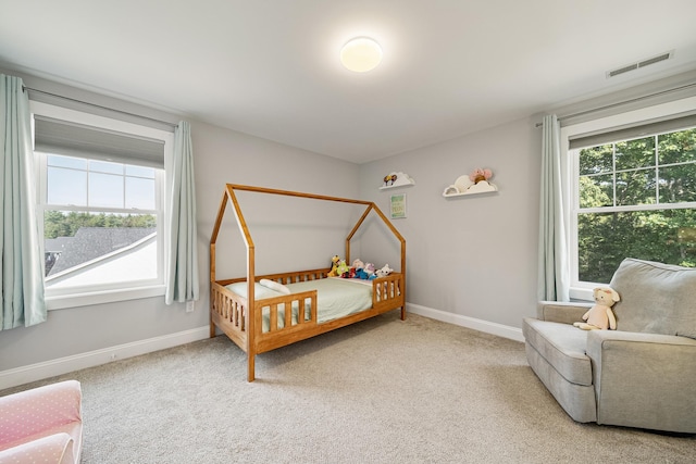 carpeted bedroom with multiple windows