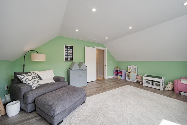 sitting room with hardwood / wood-style flooring and vaulted ceiling