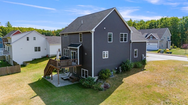 back of house with a patio area, a yard, and a deck