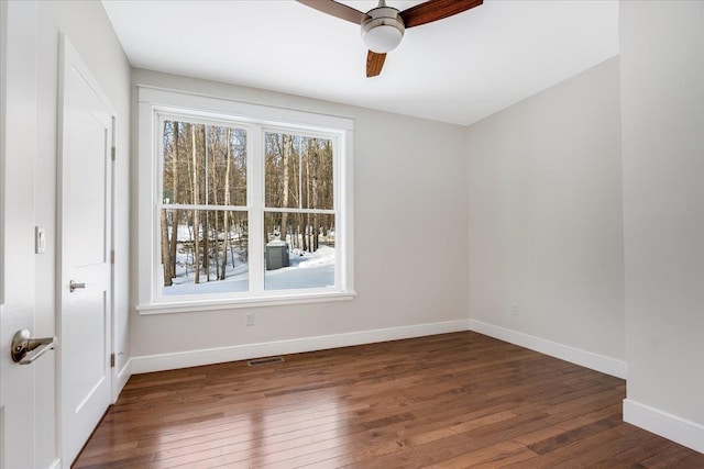 spare room featuring ceiling fan and dark hardwood / wood-style flooring