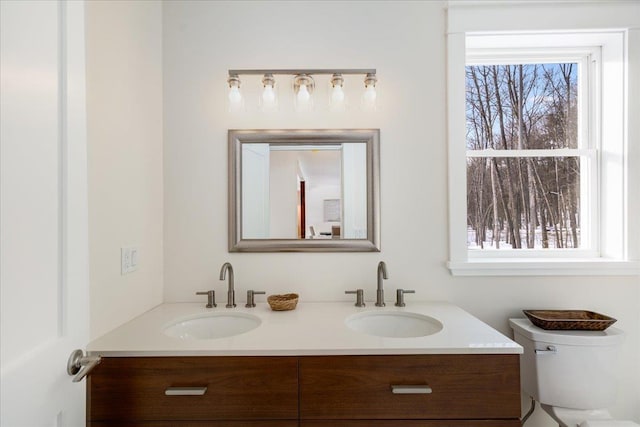 bathroom featuring vanity and toilet