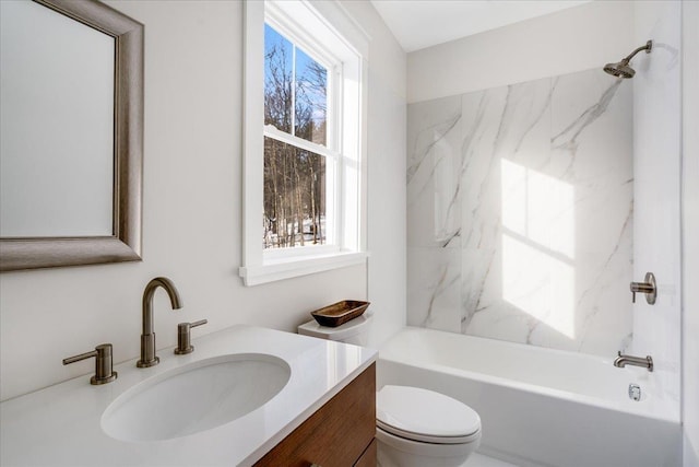 full bathroom with toilet, vanity, tiled shower / bath combo, and a healthy amount of sunlight