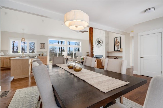 dining area with hardwood / wood-style flooring and beamed ceiling