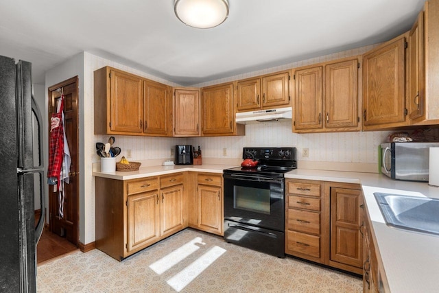 kitchen with sink and black appliances