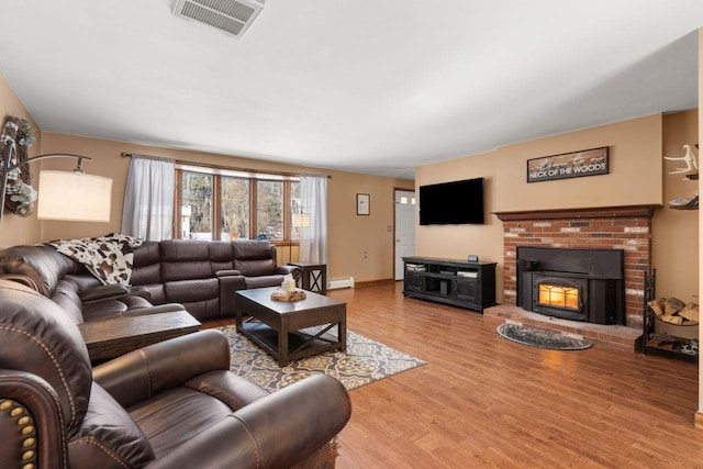 living room with baseboard heating and wood-type flooring