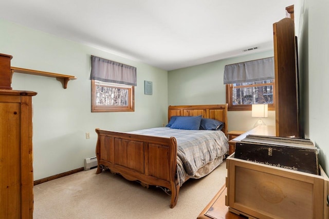 carpeted bedroom featuring multiple windows and a baseboard heating unit