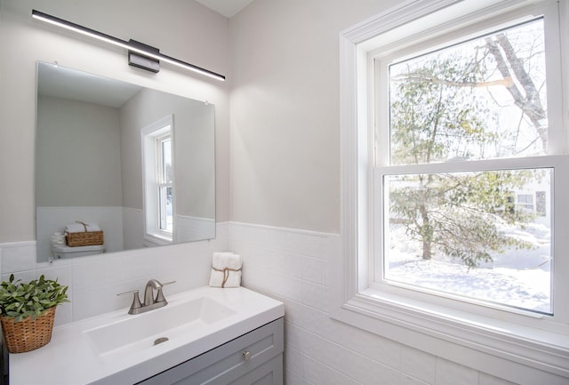 bathroom featuring tile walls, vanity, and plenty of natural light