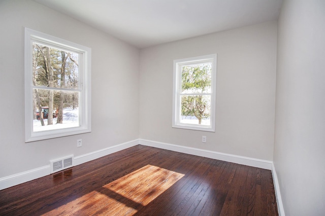 spare room with dark hardwood / wood-style floors