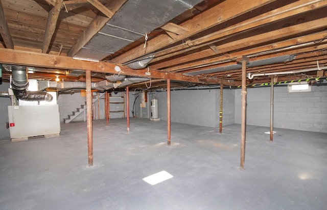 basement featuring electric water heater and heating unit