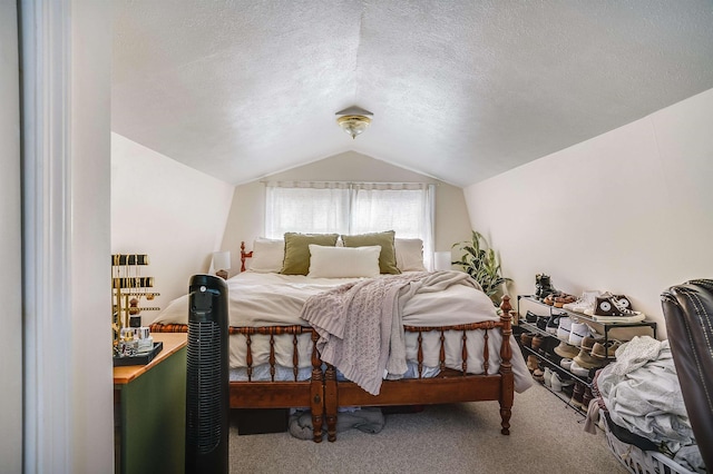 bedroom featuring carpet floors, vaulted ceiling, and a textured ceiling