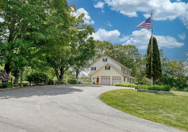 view of front of house featuring a front lawn and a garage