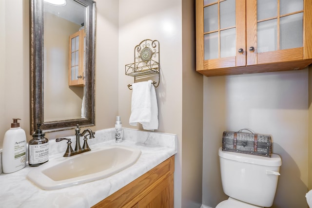 bathroom with toilet and vanity
