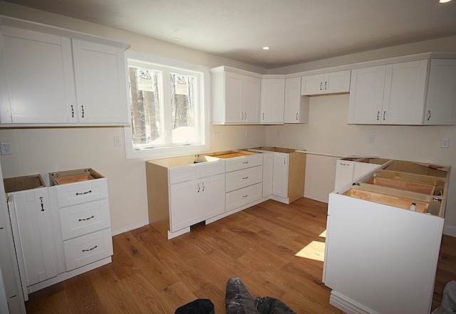 kitchen featuring wood finished floors, white cabinetry, and recessed lighting