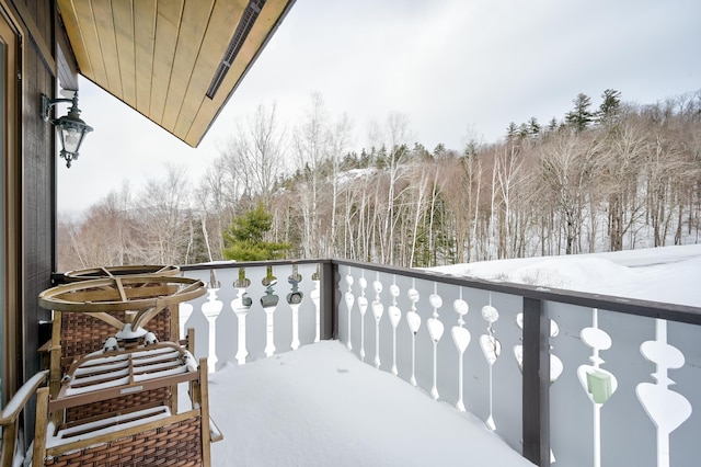 view of snow covered back of property