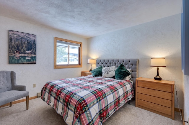 bedroom with a textured ceiling, light carpet, baseboards, and a textured wall