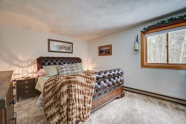 bedroom featuring a textured wall, light colored carpet, baseboard heating, and a textured ceiling