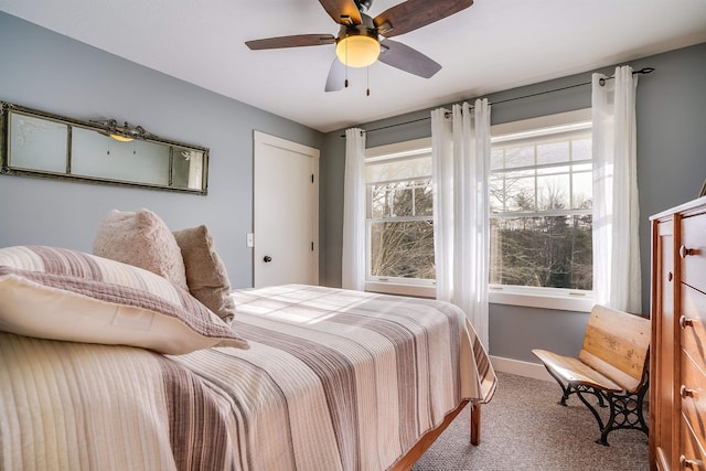 carpeted bedroom featuring ceiling fan and baseboards