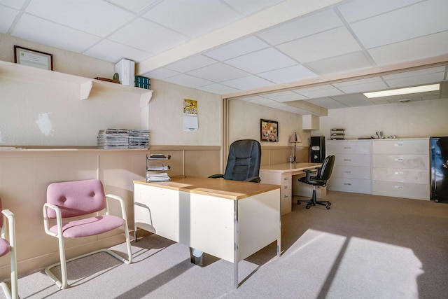 office featuring wainscoting, light carpet, and a paneled ceiling