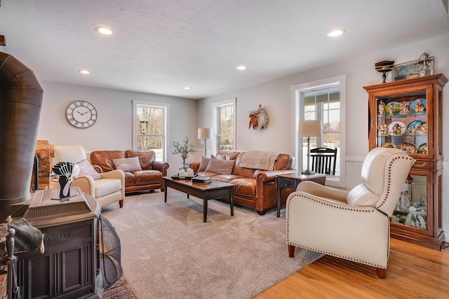 living room with light wood finished floors, recessed lighting, and a textured ceiling