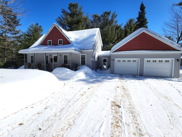 view of front of property featuring covered porch and a detached garage