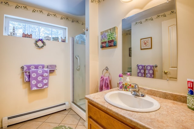 full bath with a stall shower, tile patterned floors, baseboard heating, and vanity