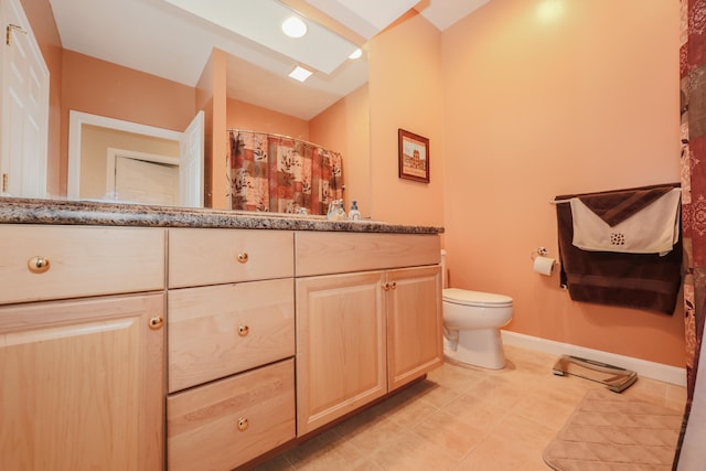 bathroom featuring baseboards, toilet, vanity, tile patterned flooring, and recessed lighting