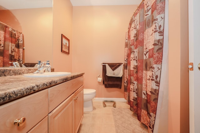 full bathroom with baseboards, vanity, tile patterned flooring, and toilet