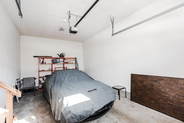 bedroom featuring concrete flooring and a garage