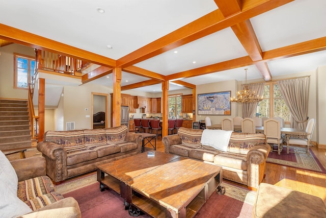 living area featuring stairs, wood finished floors, coffered ceiling, beamed ceiling, and a notable chandelier