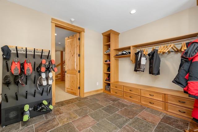 mudroom featuring baseboards, recessed lighting, and stone tile floors