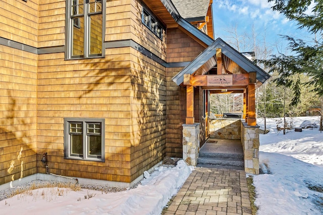 view of snow covered property entrance