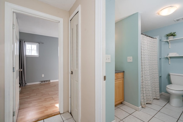 bathroom with visible vents, a closet, tile patterned floors, and toilet