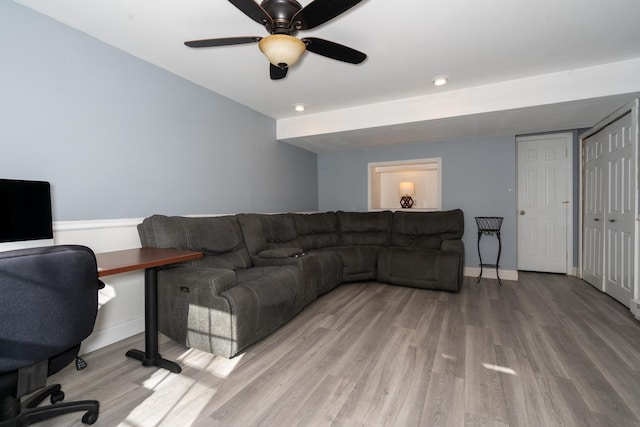 office space with baseboards, ceiling fan, and wood finished floors