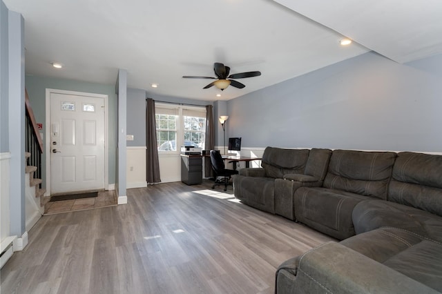 living room featuring stairway, baseboards, recessed lighting, light wood-style floors, and ceiling fan