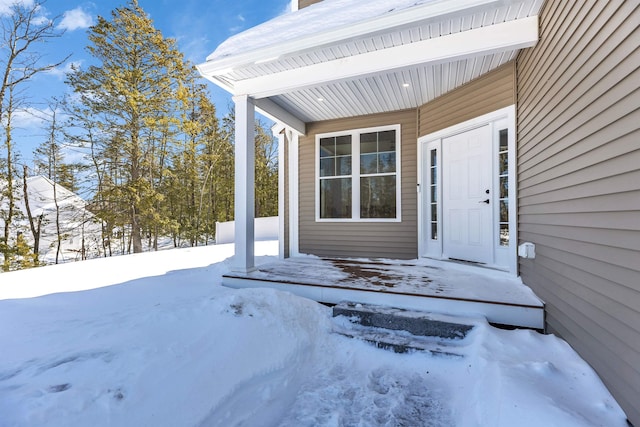 view of snow covered property entrance