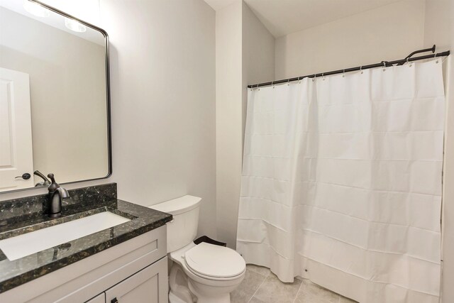 full bath featuring tile patterned floors, vanity, and toilet