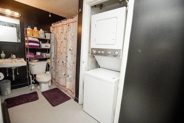 laundry room with a sink, stacked washing maching and dryer, and laundry area