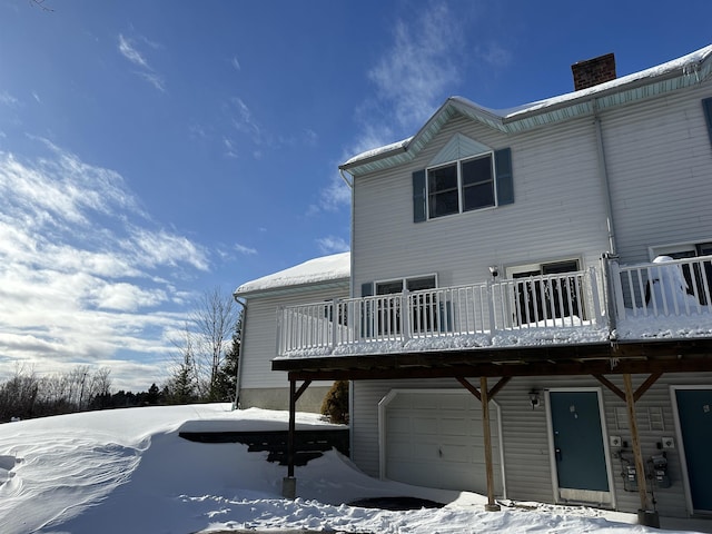 snow covered house with a chimney