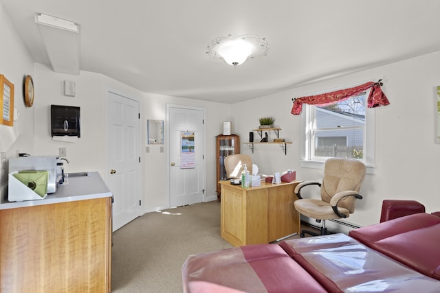 office area with light carpet and a sink