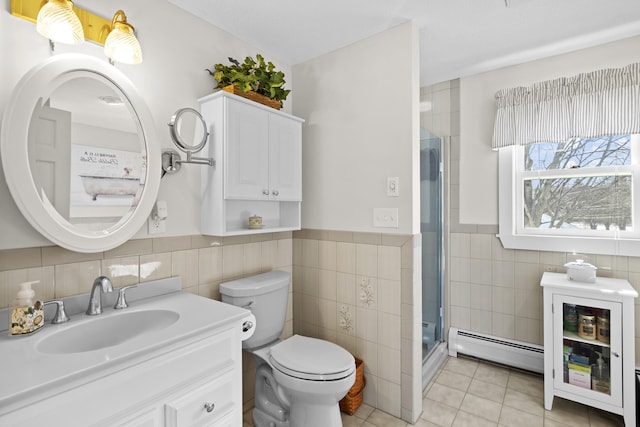 bathroom with toilet, a baseboard radiator, tile patterned flooring, a shower stall, and tile walls