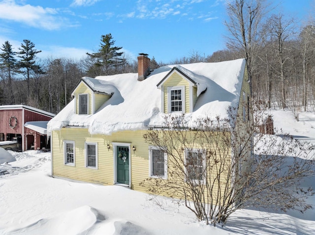 new england style home with a chimney