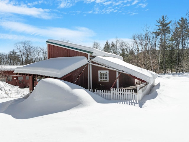 snow covered property featuring fence