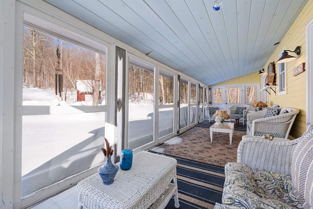 sunroom with lofted ceiling, wood ceiling, and a healthy amount of sunlight