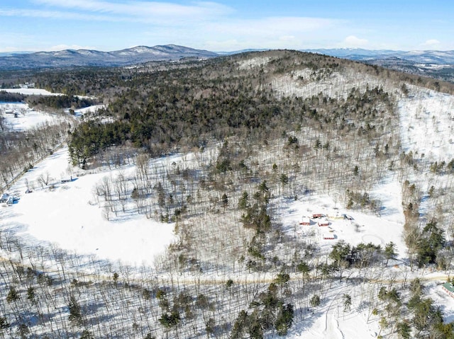 snowy aerial view with a mountain view