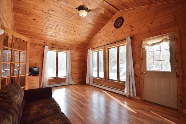 unfurnished living room with lofted ceiling, wood walls, wood finished floors, wood ceiling, and baseboard heating