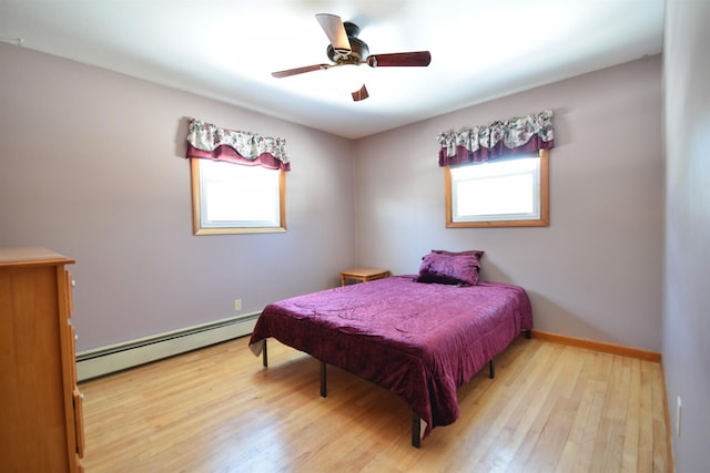 bedroom with ceiling fan, a baseboard radiator, baseboards, and light wood-style flooring