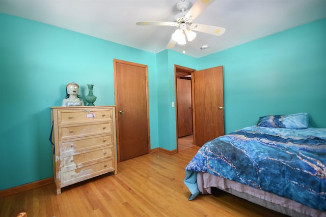 bedroom featuring baseboards, a ceiling fan, and light wood-style floors